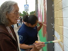 Tonkawa Tribal members add paint to the mural in Oklahoma. Tonkawa Tribal members add paint to the mural in Oklahoma.