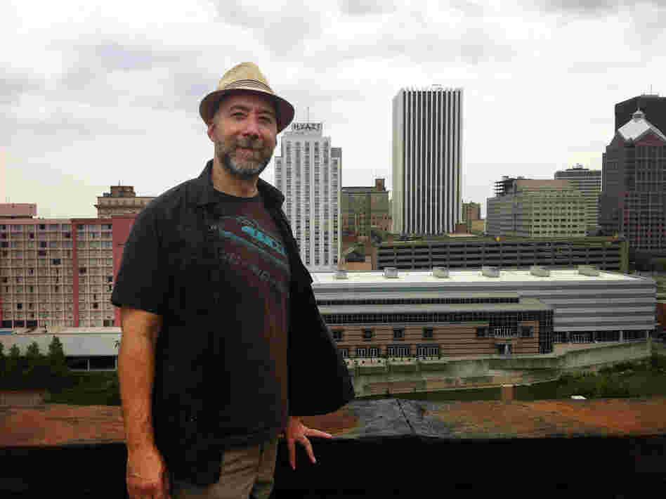Adam Frank stands atop of the Wilder Building in Rochester, N.Y.