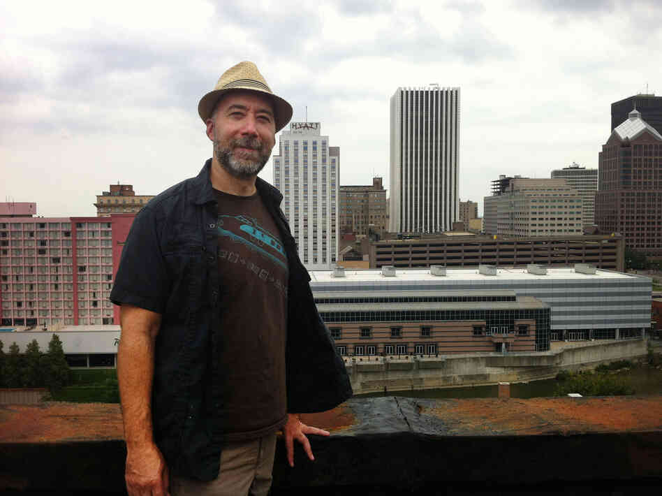 Adam Frank stands atop of the Wilder Building in Rochester, N.Y.