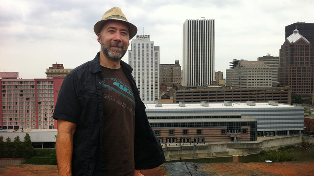 Adam Frank stands atop of the Wilder Building in Rochester, N.Y. (WXXI)