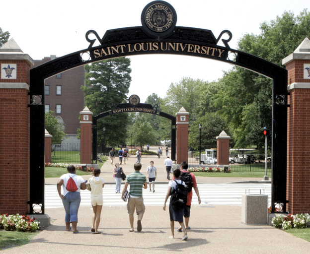 Persons walk across the campus of Saint Louis University in St. Louis in 2006.