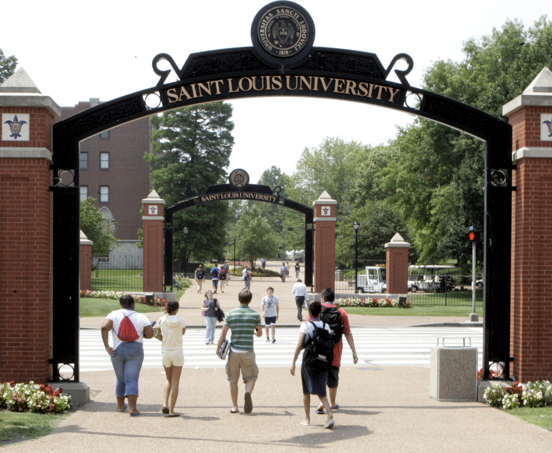 Persons walk across the campus of Saint Louis University in St. Louis in 2006.