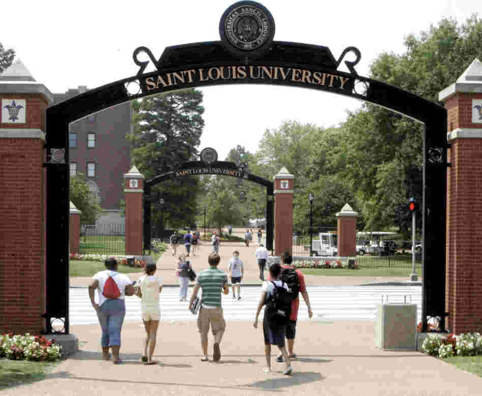 Persons walk across the campus of Saint Louis University in St. Louis in 2006.