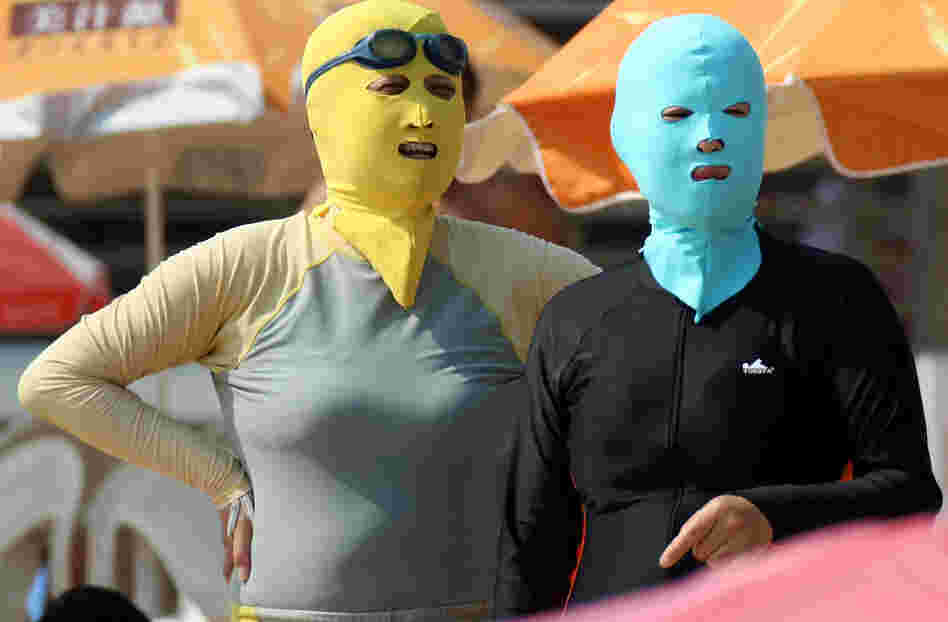 Chinese beachgoers wear face-kinis in Qingdao, northeast China's Shandong province. The face masks allow people to enjoy the water and sand — but not the effects of the sun.