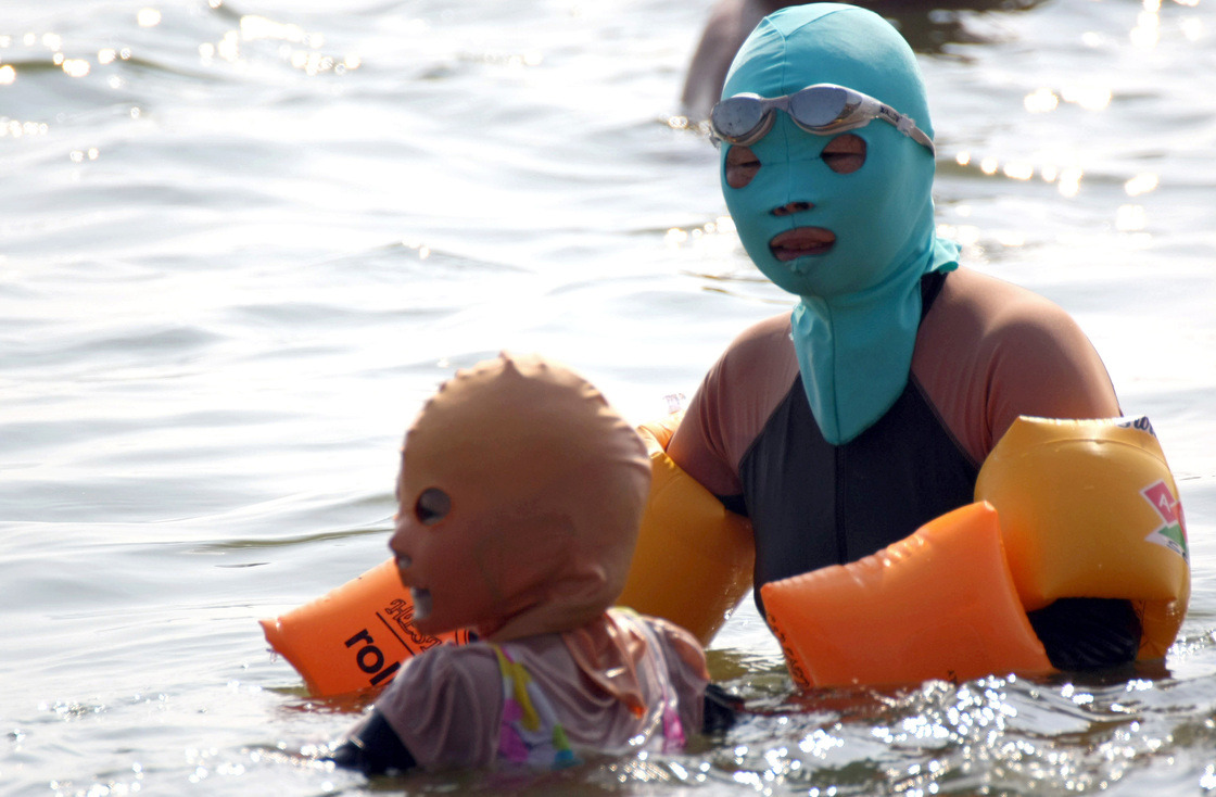 Chinese swimmers wear face-kinis at the public Huiquan Beach in Qingdao, on China's eastern coast.