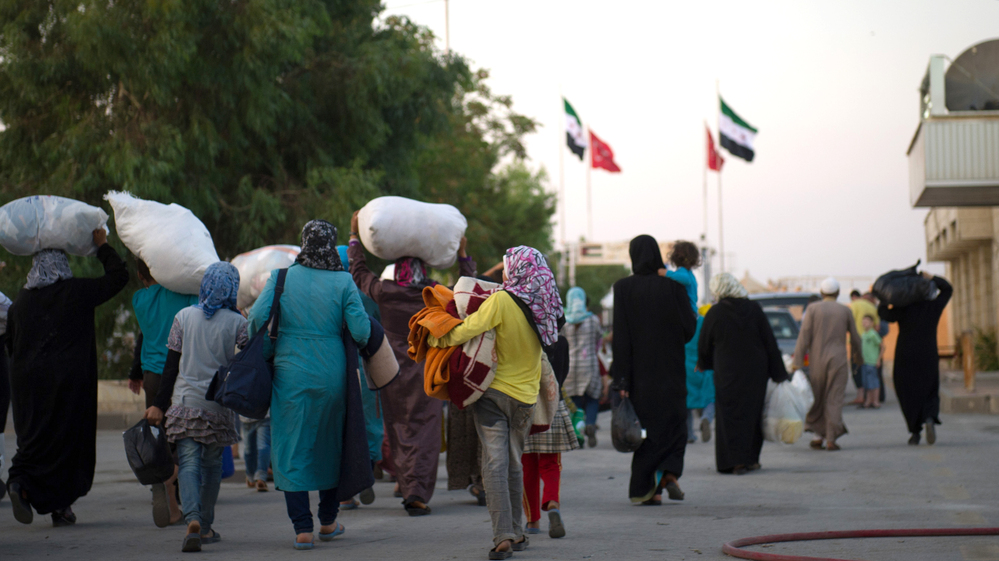 Syrians fleeing increased violence arriving last week at the border between the Syrian town of Azaz and the neighboring Turkish town of Kilis.