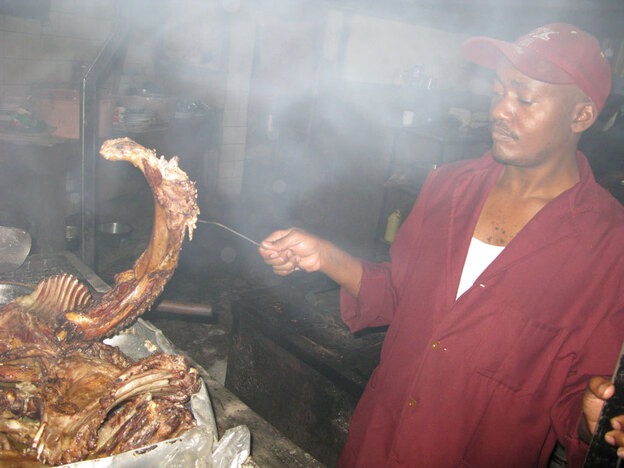 Kenyan cook Mwangi grills up nyama choma, which usually involves nearly all the parts of a goat, at the popular Sagret Hotel in Nairobi.