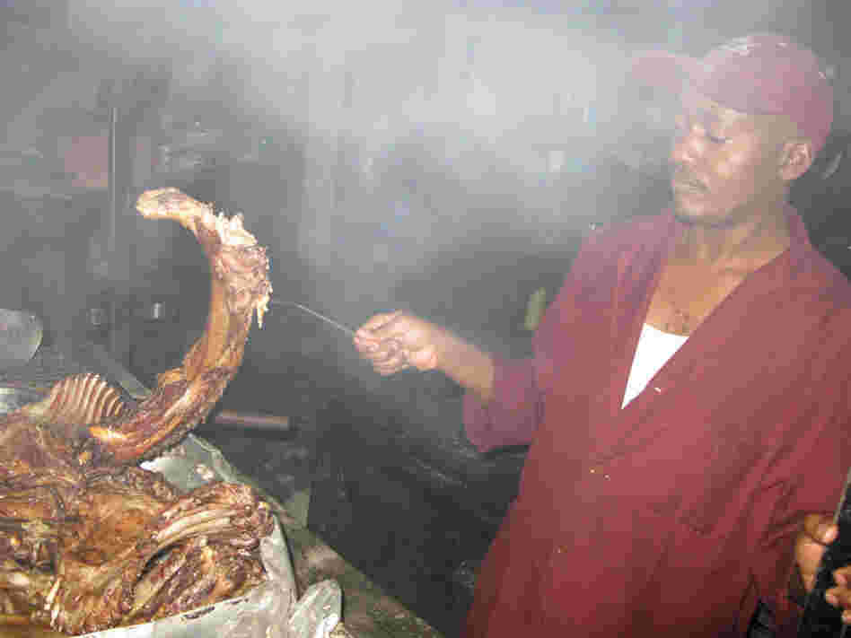 Kenyan cook Mwangi grills up nyama choma, which usually involves nearly all the parts of a goat, at the popular Sagret Hotel in Nairobi.