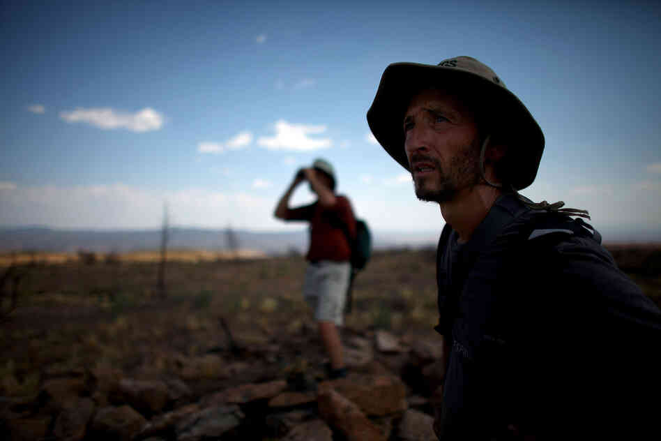 Allen (left) and Castro look across the wasteland of a plateau reduced to ashes during the Las Conchas fire. Because the fires stripped vegetation from hillsides, these areas are now vulnerable to flash floods during the summer rains.