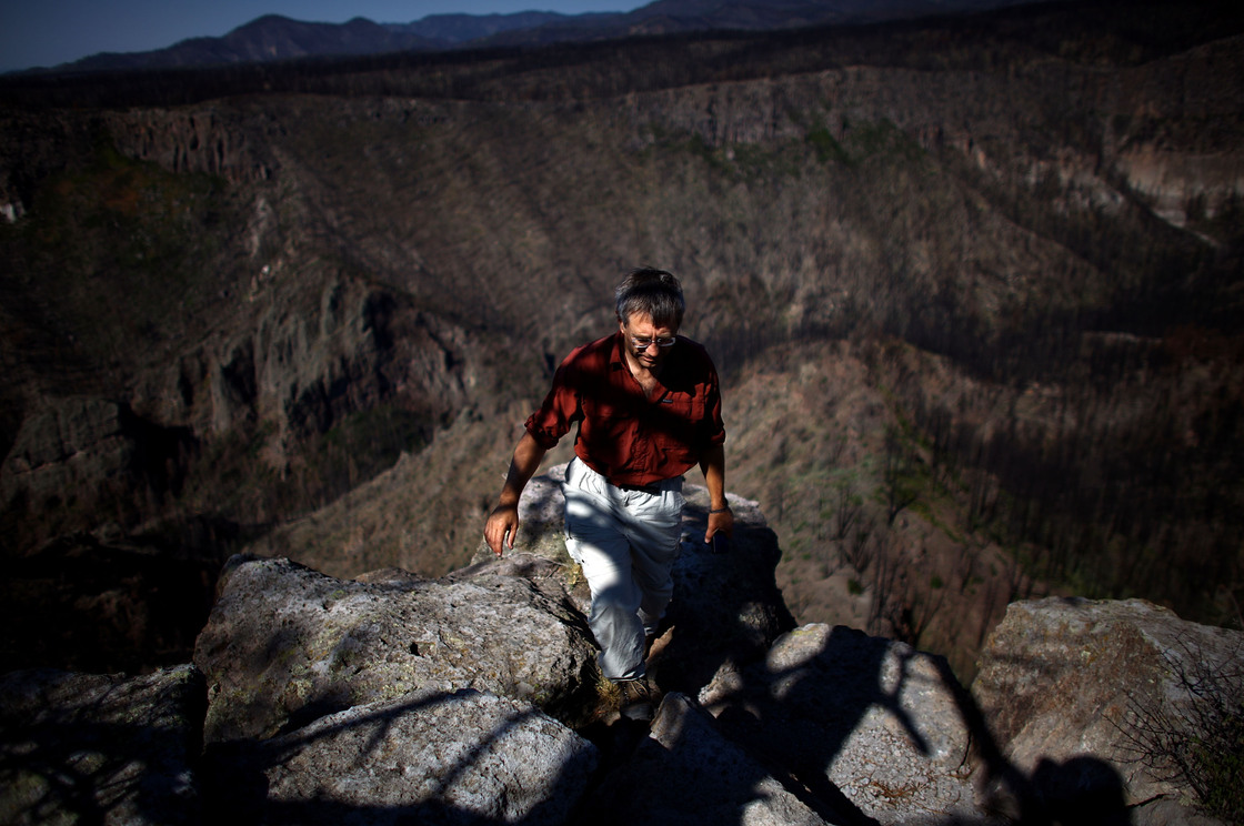 Craig Allen, a research ecologist with the U.S. Geological Survey, walks up a bluff overlooking Cochiti Canyon, which was destroyed by last year's Las Conchas megafire.