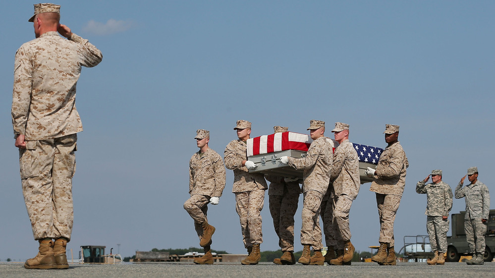Aug. 13: At Dover Air Force Base in Delaware, the remains of Marine Lance Cpl. Gregory T. Buckley are carried during a dignified transfer. He was killed in a "green on blue" attack.