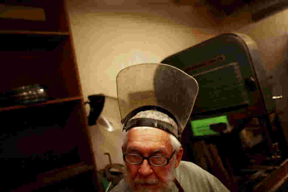 Rex Adams, a senior research specialist at the Laboratory of Tree-Ring Research, steps away from a band saw that he uses to slice tree ring samples.