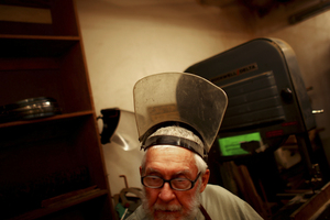 Rex Adams, a senior research specialist at the Laboratory of Tree-Ring Research, steps away from a band saw that he uses to slice tree ring samples.