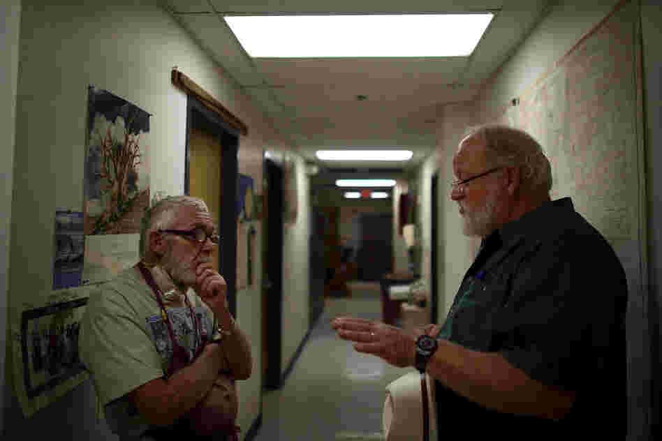 Adams (left) talks with Swetnam in their laboratory, nestled under the football stadium.