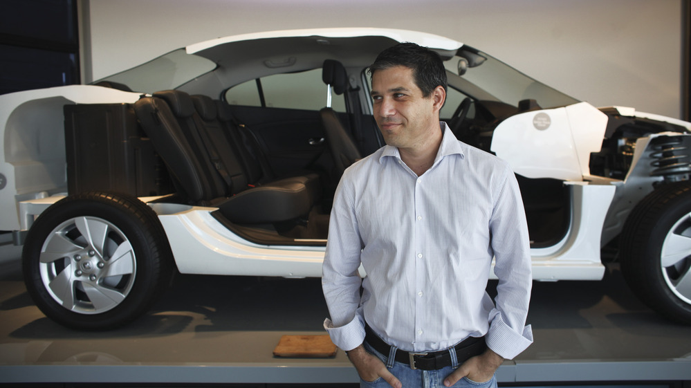 Better Place is building a network of electric car battery changing stations throughout Israel. The idea is to make changing a spent electric battery as easy as pulling into the gas station for gasoline. Here, Better Place CEO Shai Agassi is shown in front of a cutaway model of an electric car at the company's showroom in Tel Aviv earlier this month.