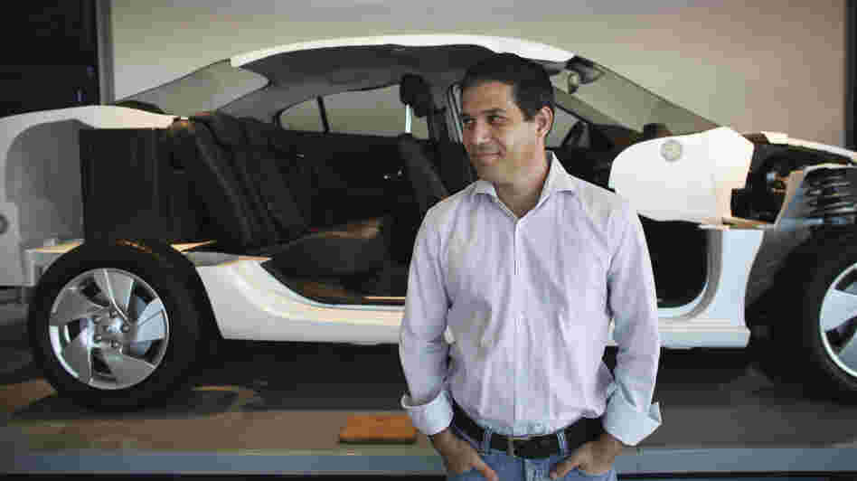 Better Place is building a network of electric car battery changing stations throughout Israel. The idea is to make changing a spent electric battery as easy as pulling into the gas station for gasoline. Here, Better Place CEO Shai Agassi is shown in front of a cutaway model of an electric car at the company's showroom in Tel Aviv earlier this month.