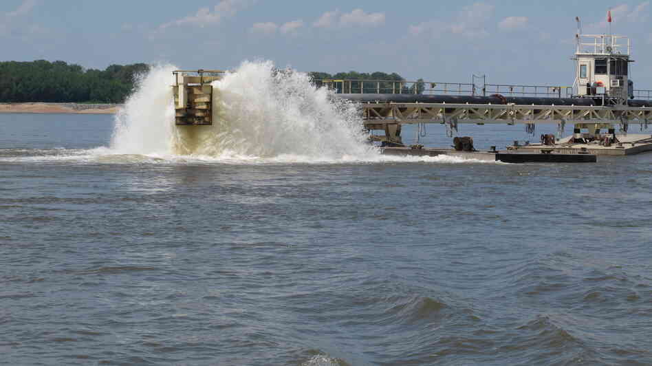 Water gets churned up at the end of a dredging pipeline connected to a U.S. Army Corps of Engineers dredge on the Mississippi River near Memphis, Tenn., on Monday. The river has seen water levels from Illinois to Louisiana plummet because of drought conditions in the past three months. When there's less flow coming downstream, saltwater from the Gulf wedges its way in.