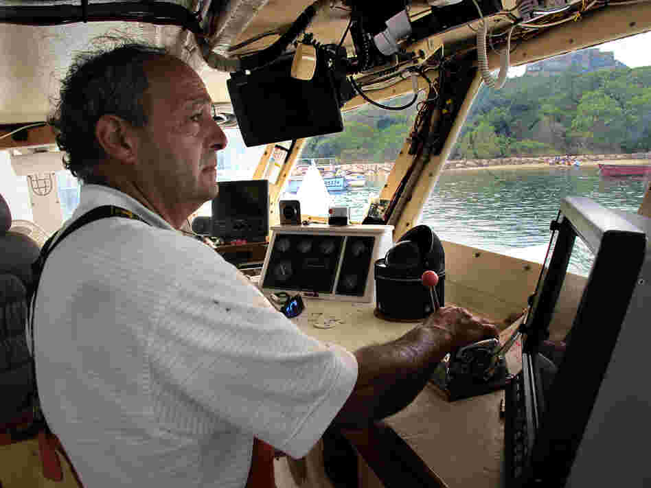 Boat captain Bill Amaru pilots his trawler, the Joanne-A III, to its mooring in Chatham Harbor on Cape Cod after a cod fishing trip.