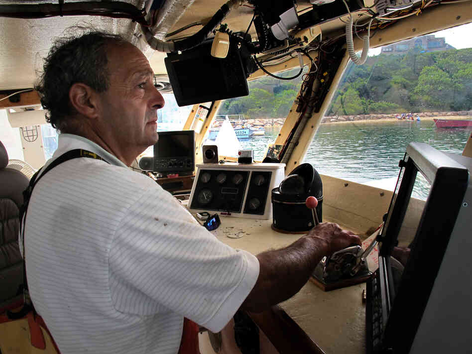 Boat captain Bill Amaru pilots his trawler, the Joanne-A III, to its mooring in Chatham Harbor on Cape Cod after a cod fishing trip.