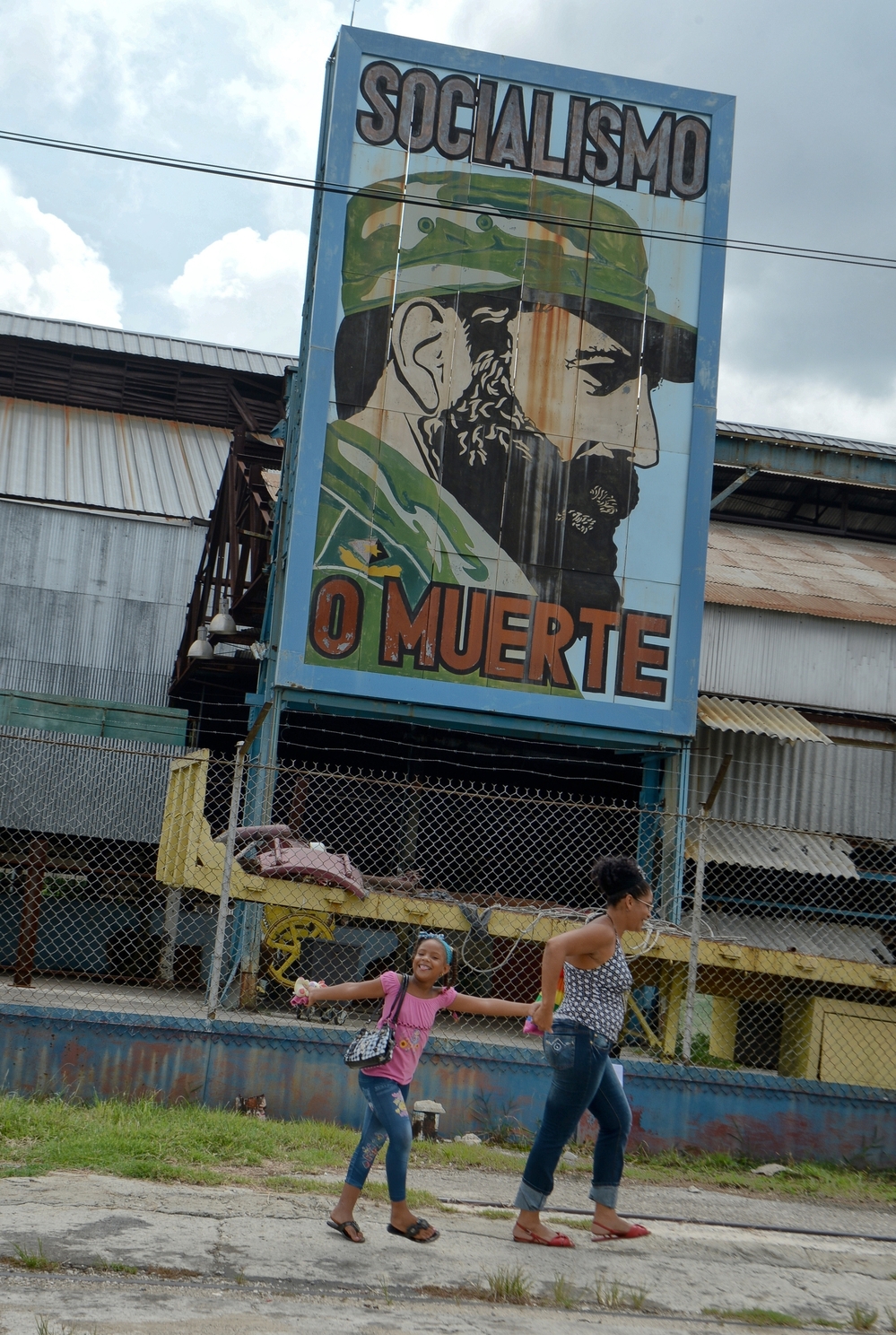 Cubans pass by a billboard celebrating the 86th birthday of former Cuban President Fidel Castro, on Aug. 13 in Havana. Castro celebrated his birthday quietly and out of the public eye, while political allies and Cuban citizens paid tribute from afar.