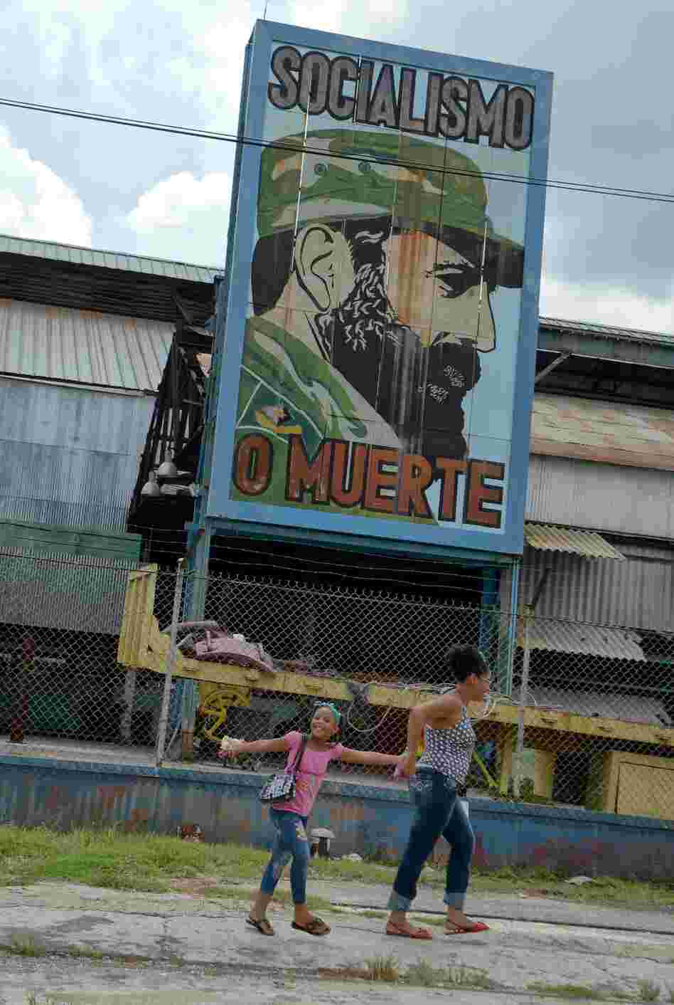 Cubans pass by a billboard celebrating the 86th birthday of former Cuban President Fidel Castro, on Aug. 13 in Havana. Castro celebrated his birthday quietly and out of the public eye, while political allies and Cuban citizens paid tribute from afar.