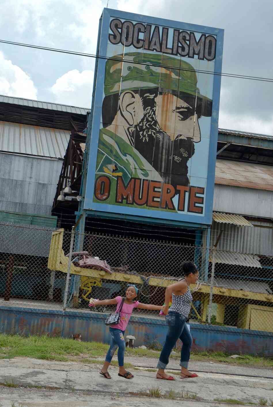 Cubans pass by a billboard celebrating the 86th birthday of former Cuban President Fidel Castro, on Aug. 13 in Havana. Castro celebrated his birthday quietly and out of the public eye, while political allies and Cuban citizens paid tribute from afar.