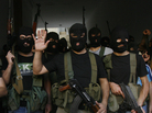 Lebanese masked gunmen from the al-Mokdad clan gather for a news conference in Beirut's southern suburbs on Aug. 15. The Mokdads, a large Lebanese Shiite Muslim clan, said they kidnapped at least 20 Syrians to try to secure the release of a family member abducted by Syrian rebels near Damascus this week. Lebanese masked gunmen from the al-Mokdad clan gather for a news conference in Beirut's southern suburbs on Aug. 15. The Mokdads, a large Lebanese Shiite Muslim clan, said they kidnapped at least 20 Syrians to try to secure the release of a family member abducted by Syrian rebels near Damascus this week.