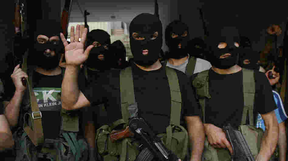 Lebanese masked gunmen from the al-Mokdad clan gather for a news conference in Beirut's southern suburbs on Aug. 15. The Mokdads, a large Lebanese Shiite Muslim clan, said they kidnapped at least 20 Syrians to try to secure the release of a family member abducted by Syrian rebels near Damascus this week.