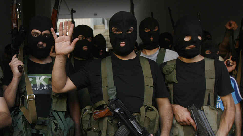 Lebanese masked gunmen from the al-Mokdad clan gather for a news conference in Beirut's southern suburbs on Aug. 15. The Mokdads, a large Lebanese Shiite Muslim clan, said they kidnapped at least 20 Syrians to try to secure the release of a family member abducted by Syrian rebels near Damascus this week.