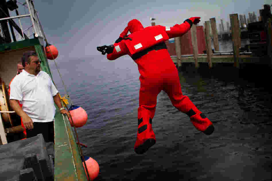Mattera coaches a fisherman as he plunges into the water during a vessel disaster simulation.