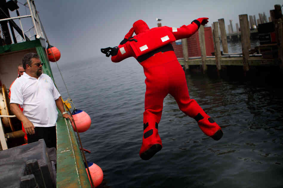 Mattera coaches a fisherman as he plunges into the water during a vessel disaster simulation.