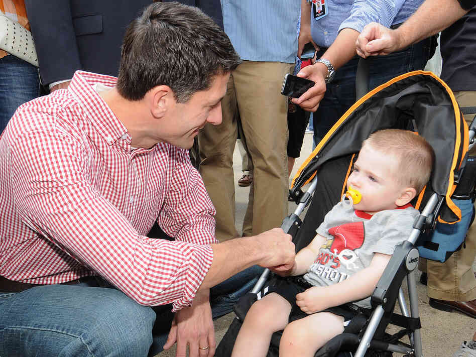 Republican vice presidential candidate Paul Ryan greets a young boy during a campagin stop at the Des Moines Register Soap Box at the Iowa State Fair August 13, 2012, in Des Moines, Iowa.