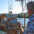 A local artist paints the scene at the Port of Toledo's Wooden Boat Show in August 2011.