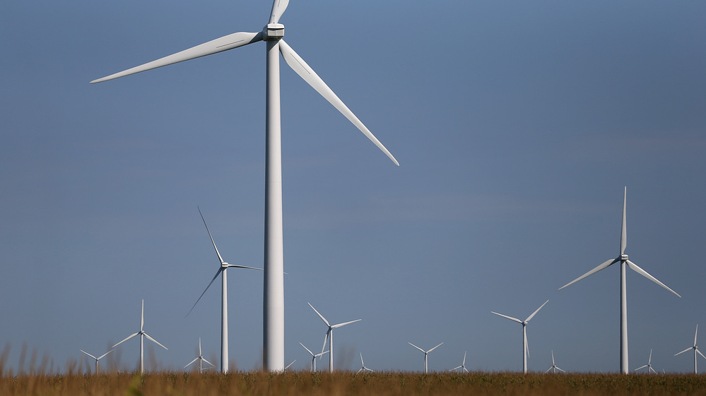 Windmills in a corn field in Colo, Iowa.
