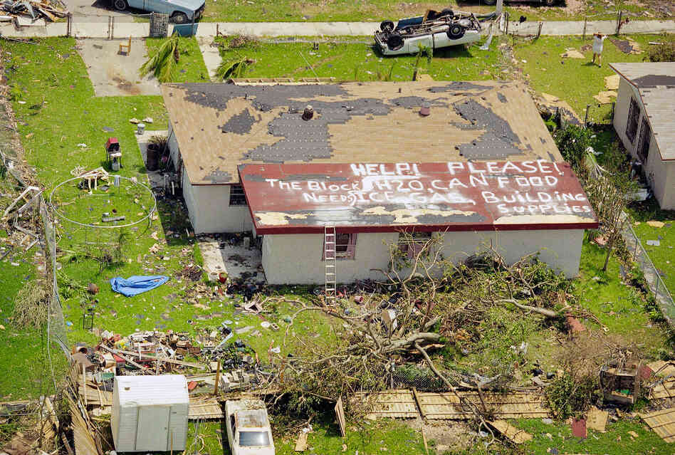 A resident of Homestead, Fla., asks for help on Aug. 26, 1992, two days after the area was ravaged by Hurricane Andrew. The sign on the roof reads, "Help please! The block needs H20, can food, ice, gas, building supplies." Homestead was one of the hardest hit areas.