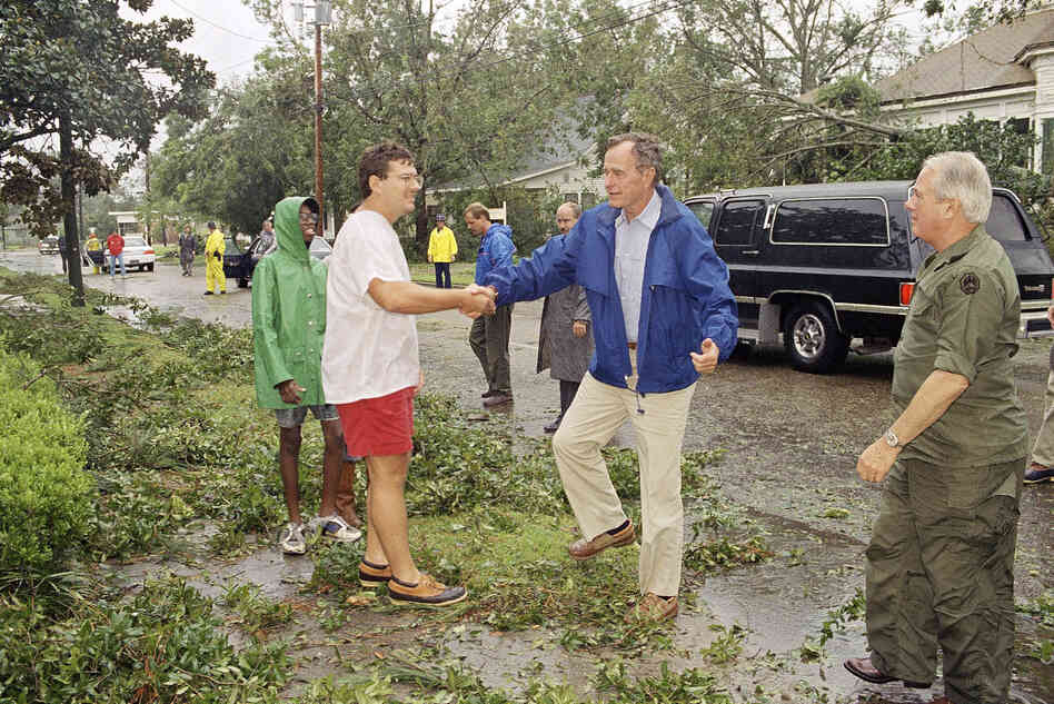 President George H.W. Bush talks to Dave Cavalier during a visit to view storm damage in New Iberia, La. 
