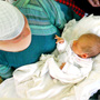 Family members and friends gather around 8-day-old Israeli baby Oz Naftaly Cohen after his traditional Jewish circumcision ceremony in 2005. Family members and friends gather around 8-day-old Israeli baby Oz Naftaly Cohen after his traditional Jewish circumcision ceremony in 2005.