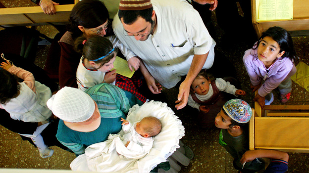 Family members and friends gather around 8-day-old Israeli baby Oz Naftaly Cohen after his traditional Jewish circumcision ceremony in 2005.