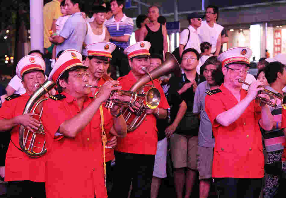 The "Loving Happiness Band," supported, in part, by the Communist Party, plays for a crowd on Nanjing Road.