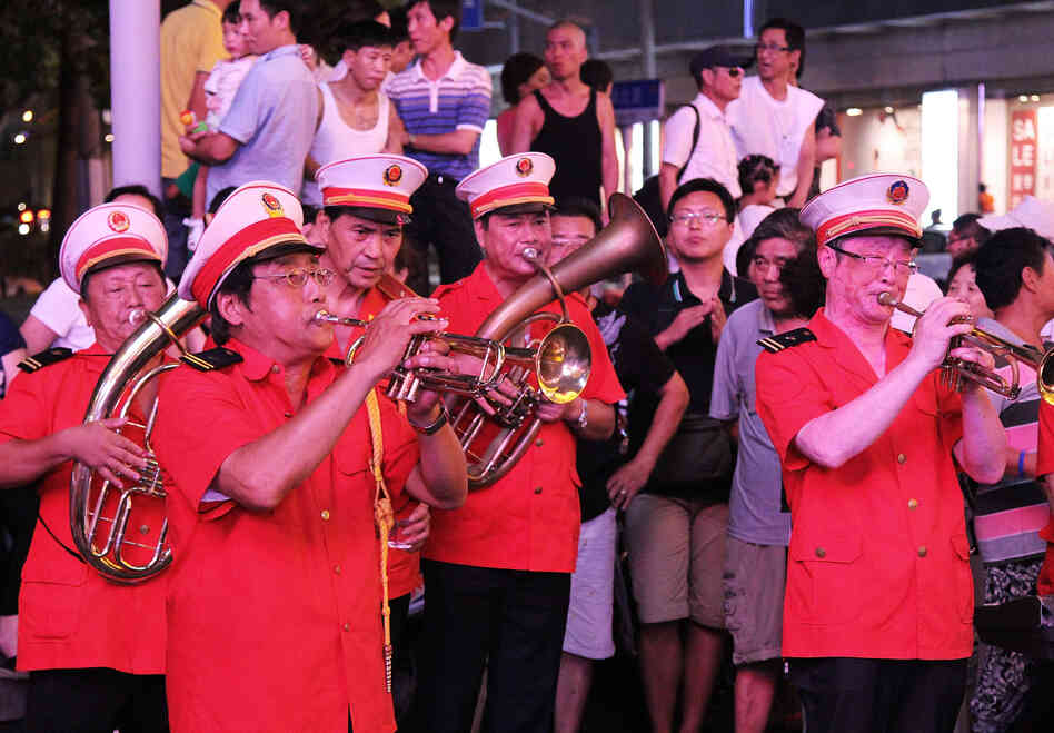 The "Loving Happiness Band," supported, in part, by the Communist Party, plays for a crowd on Nanjing Road.