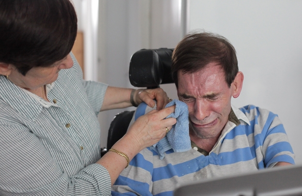 Tony Nicklinson's wife, Jane, wipes his tears as he learns that a court has denied him the right to medically assisted suicide on Aug. 16, 2012.