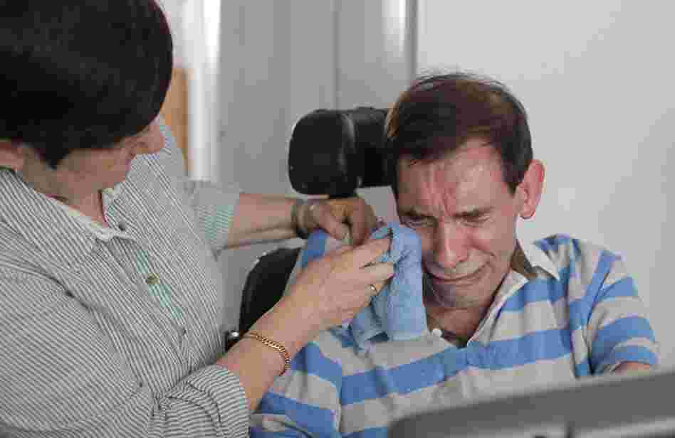 Tony Nicklinson's wife, Jane, wipes his tears as he learns that a court has denied him the right to medically assisted suicide on Aug. 16, 2012.