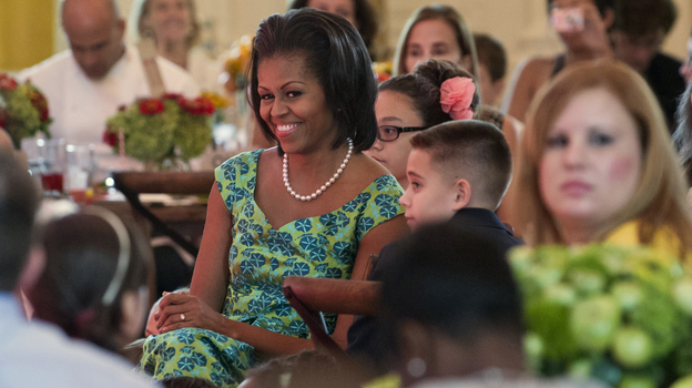 First lady Michelle Obama sits with guests as they eat lunch during a kids' state dinner at the White House on Monday.