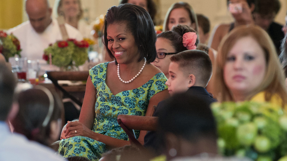 First lady Michelle Obama sits with guests as they eat lunch during a kids' state dinner at the White House on Monday.