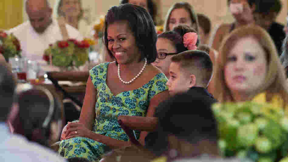 First lady Michelle Obama sits with guests as they eat lunch during a kids' state dinner at the White House on Monday.