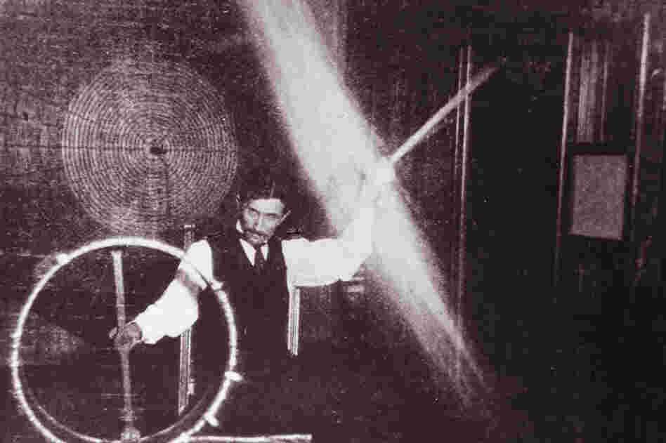 In this photo from 1898, Tesla is sending 500,000 volts through his body to light the lightbulb as he spins it around above his head.