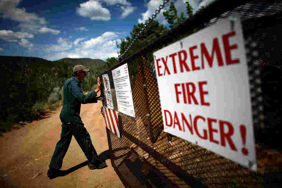 Bill Armstrong of the U.S. Forest Service opens the security gate at the Santa Fe watershed, in New Mexico's Sangre de Cristo mountains.