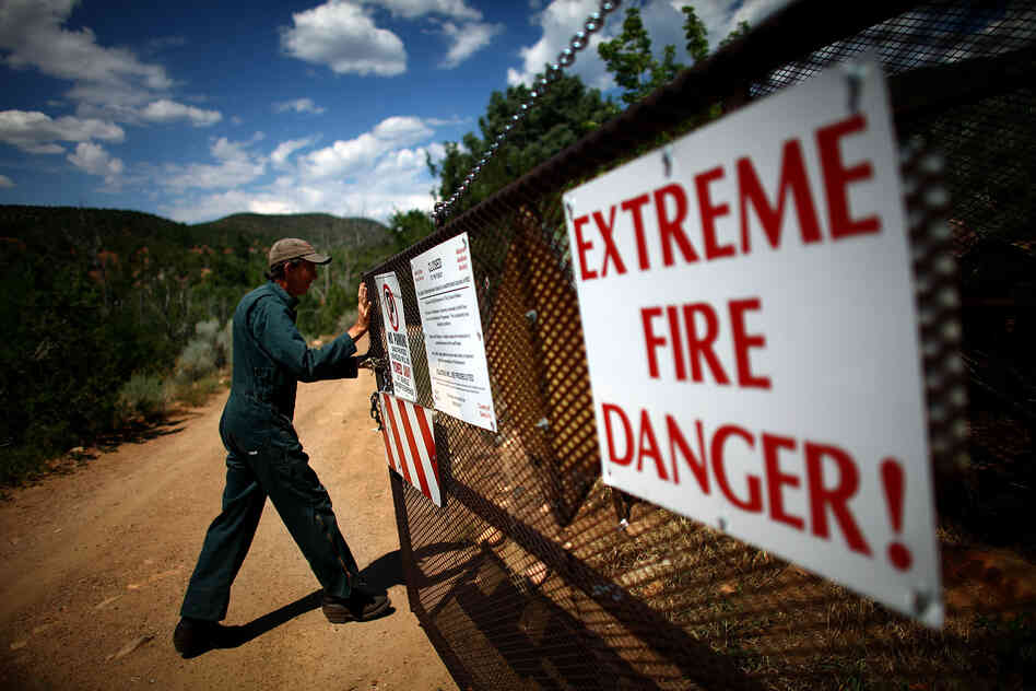 Bill Armstrong of the U.S. Forest Service opens the security gate at the Santa Fe watershed, in New Mexico's Sangre de Cristo mountains.