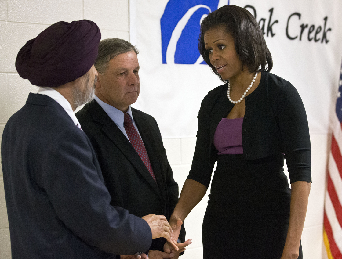 First lady Michelle Obama greets Sikh temple secretary of the board of trustees Kulwant Singh Dhaliwal, left, and Oak Creek, Wis.