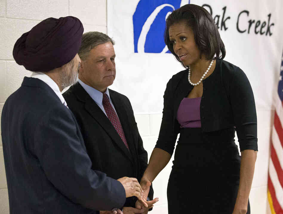 First lady Michelle Obama greets Sikh temple secretary of the board of trustees Kulwant Singh Dhaliwal, left, and Oak Creek, Wis.
